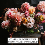 A large floral arrangement in a glass vase on a dark wooden table against a black background, with a text banner at the bottom reading 'COASTAL BLOOMS SUNSET COLOR PALETTE WORKSHOP'. The flowers are predominantly pink, peach, coral, and cream tones with some yellow and green accents.
